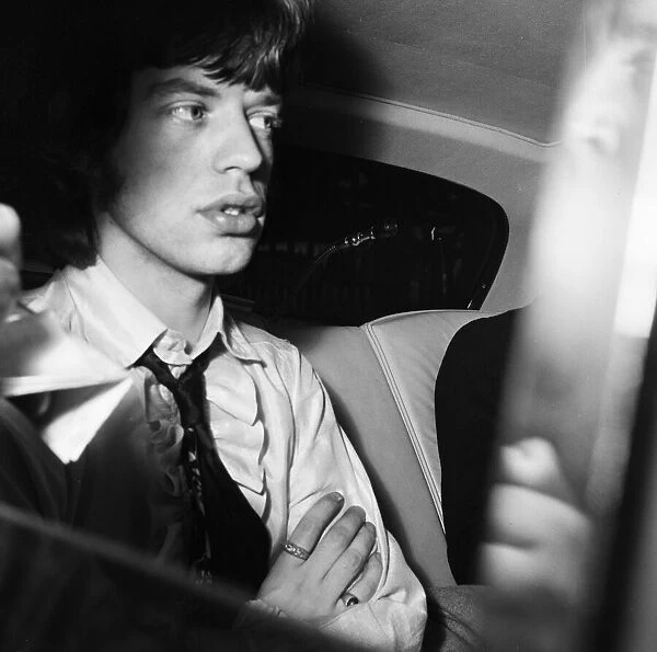Mick Jagger of the Rolling Stones pop group departs from Wormwood Scrubs after he arrived