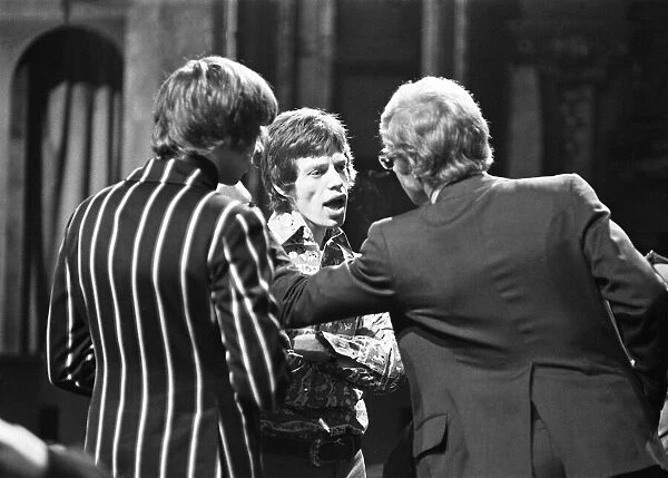 Mick Jagger talking to The Rolling Stones manager Andrew Loog Oldham (right