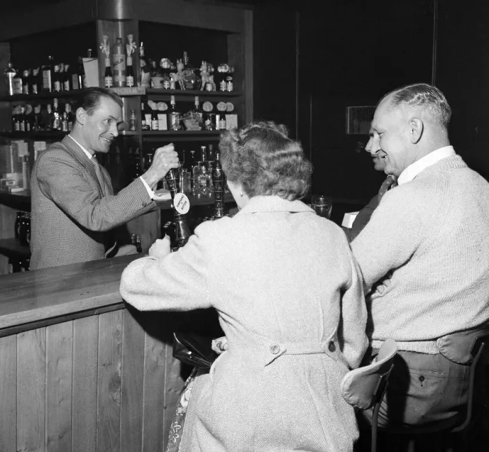 Framed Print : Former Middlesbrough footballer Wilf Mannion serving customers at the bar in his pub