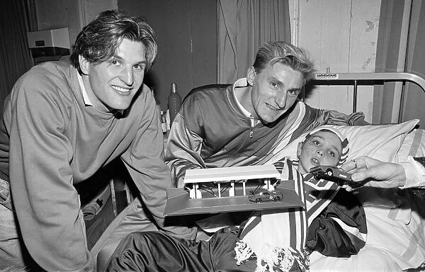 Middlesbrough footballers, Tony Mowbray (right), hand out presents to children at