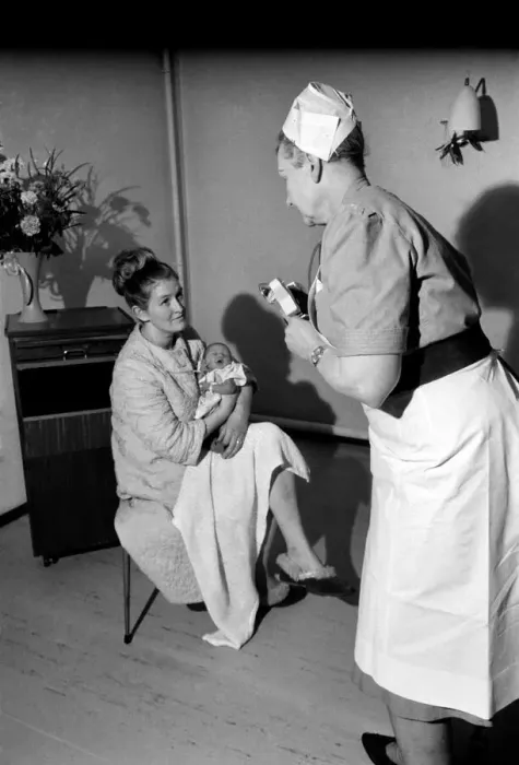 Framed Print : Midwife May Guthrie-Lacy photographs the 287th baby which she has delivered at Lytham