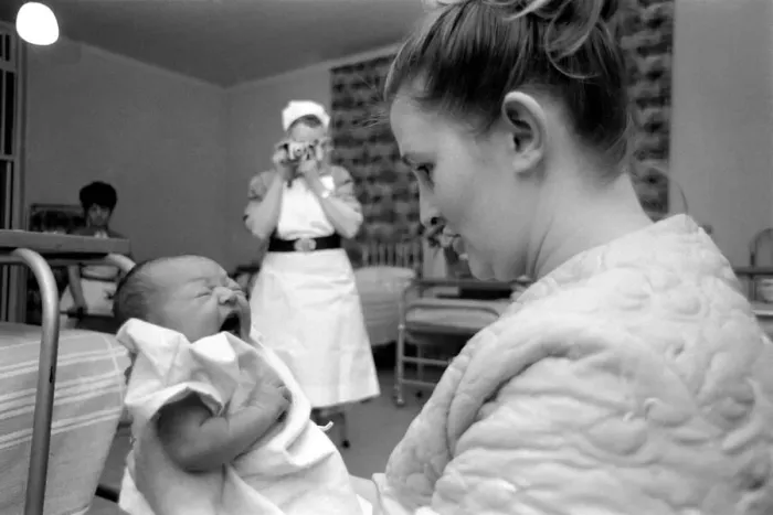 Framed Print : Midwife May Guthrie-Lacy photographs the 287th baby which she has delivered at Lytham