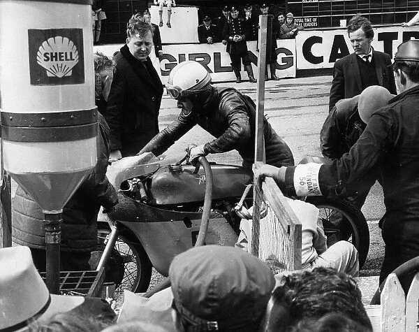 Mike Hailwood refuels during a pit stop in IOM TT 1965