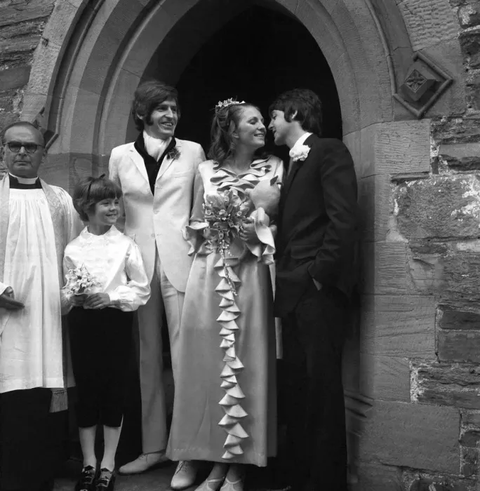 Framed Print : Mike McCartneys Wedding. A kiss for the bride from Paul McCartney watched by Framed Print : Mike McCartneys Wedding. A kiss for the bride from Paul McCartney watched by