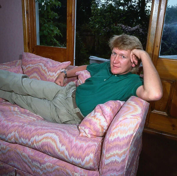 Mike Smith DJ disc jockey TV presenter lying lounging on couch settee sofa