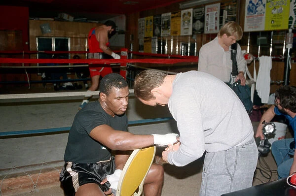 Mike Tyson in his training camp with trainer Kevin Rooney ahead of his bout with James