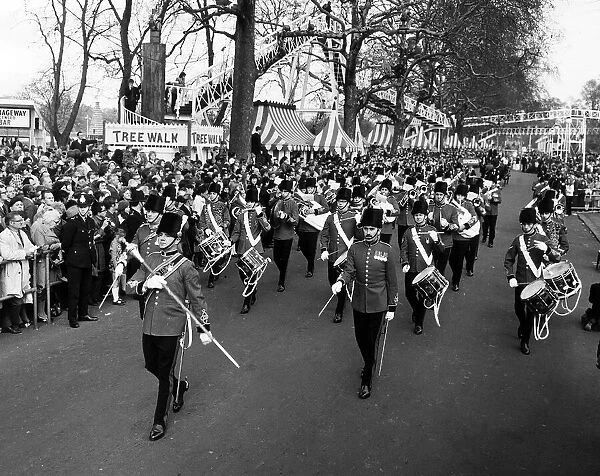 A military band leads the Battersea Easter Parade of 1971 as crowds gather to watch