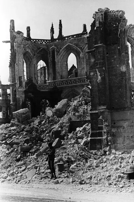 Framed Print : US Military Policeman guards the ruins of the Cathedral of Valognes against looters after