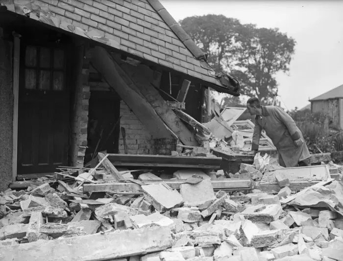 Framed Print : Milkman examines the staircase of a damage house in Tyburn Road, Edrdington Framed Print : Milkman examines the staircase of a damage house in Tyburn Road, Edrdington