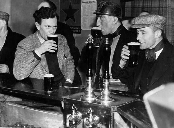 Miners enjoying a drink after work. 4th February 1947