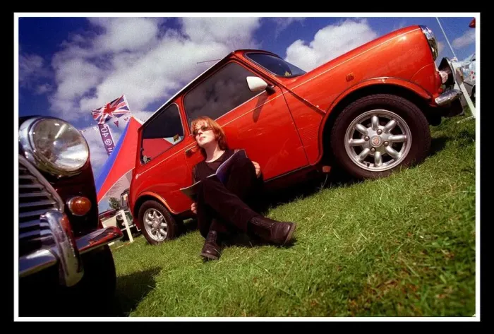 Framed Print : Mini car August 1999 Woman sitting leaning against red Mini in the sun reading brochure Framed Print : Mini car August 1999 Woman sitting leaning against red Mini in the sun reading brochure