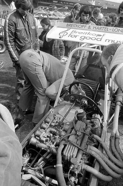 Mini Grand Prix: White City Stadium: Graham Hill sorting out a few performance problems