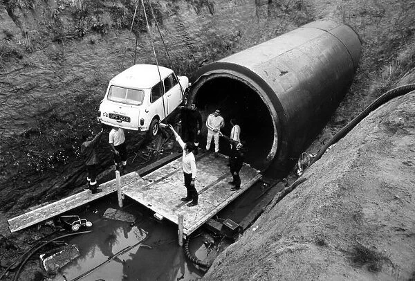 A Mini is lowered into Coventry sewers during the filming of 'The Italian Job'