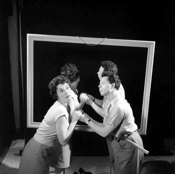 Framed Print : Mirror image: A couple argue in front of a mirror. 1958 Framed Print : Mirror image: A couple argue in front of a mirror. 1958