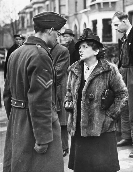 Miss Ellen Wilkinson sympathising with Corporal LG Biddle, whose twins, aged 5