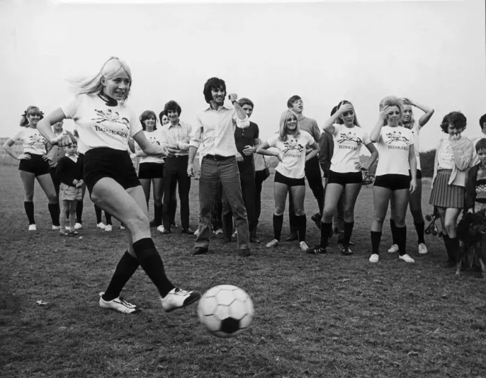 Framed Print : Miss Eva Haralsted takes a penalty shot under the watchful eye of fiancee George Best Framed Print : Miss Eva Haralsted takes a penalty shot under the watchful eye of fiancee George Best