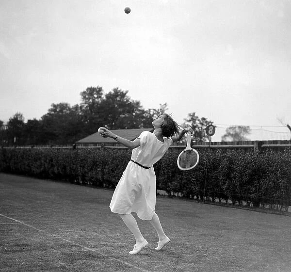 Miss Evelyn. Colyer going for an overhead shot on the tennis court June 1923