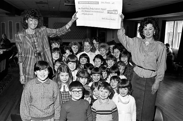 Miss Examiner Madeleine Garbutt (left) is presented with a £1
