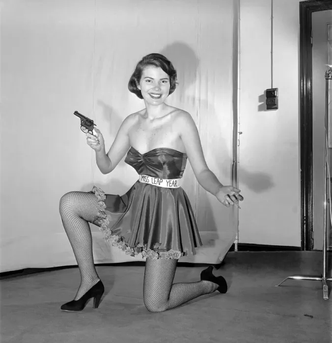Framed Print : Miss Leap Year: Belinda Penelope seen here proposing to boyfriend holding a gun