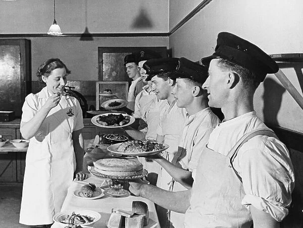 Miss Lloyd-Davies tries the dishes of her pupils at a cooking school in Suffolk