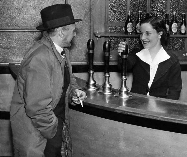 Miss Nora Collins chatting with a customer in her public house, 21st March 1938