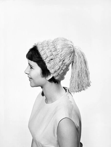 Model Ann Cave wearing knitted hat. Circa 1960