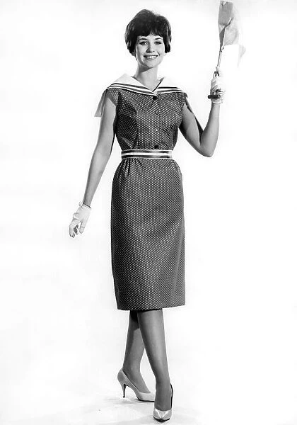 Model Ann Cave wearing a stylish sleveless three quarter length dress