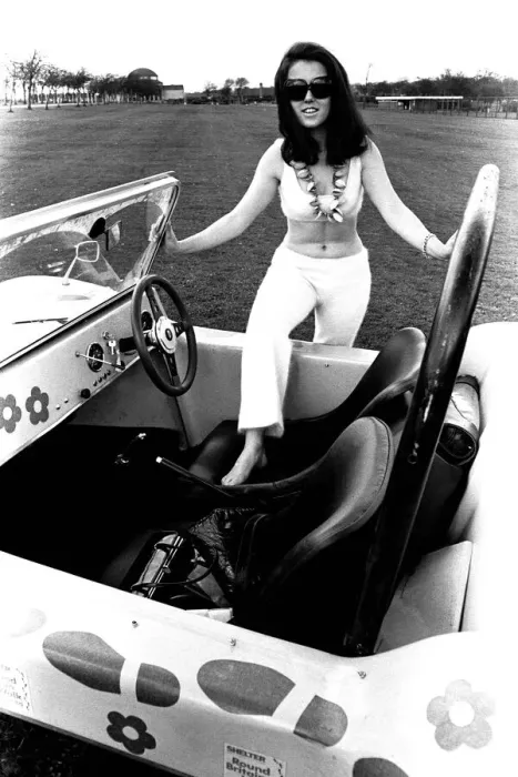 Framed Print : A model in a beach buggy wearing a blouse and trousers in April 1970
