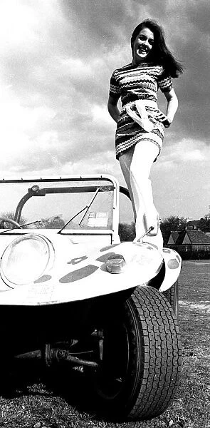 A model in a beach buggy wearing a dress in April 1970