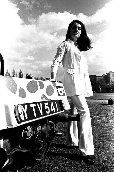 A model in a beach buggy wearing a raincoat in April 1970