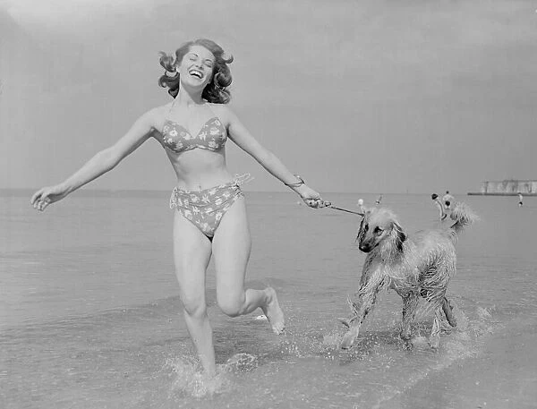 Model Belinda Lee seen here with here Afghan hounds on the beach at Cliftonville, Kent
