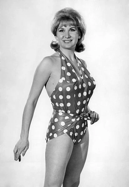 Model Caron Gardner wearing a polka dot patterned swimsuit