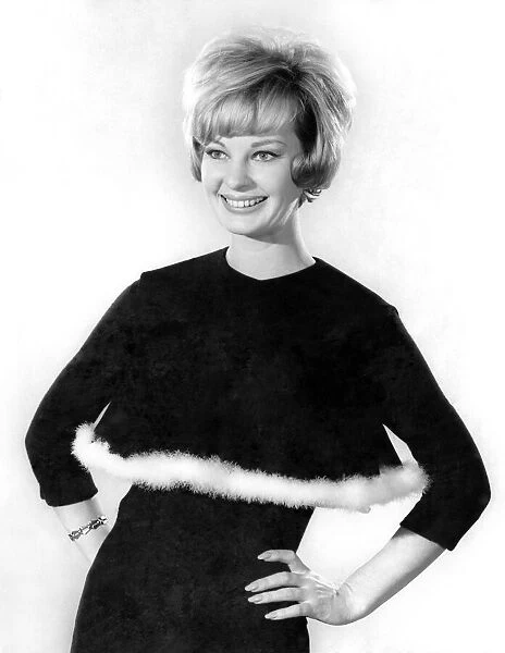 Model Dawn Chapman wearing a black long sleeved top with white fur trim