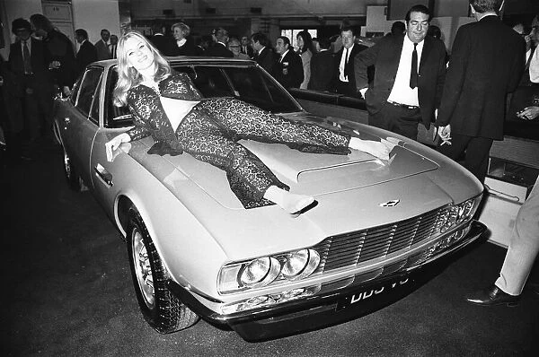 Model drapped over the bonnet of an Aston Martin DBS V8 at the 1969 Motor Show 1st June