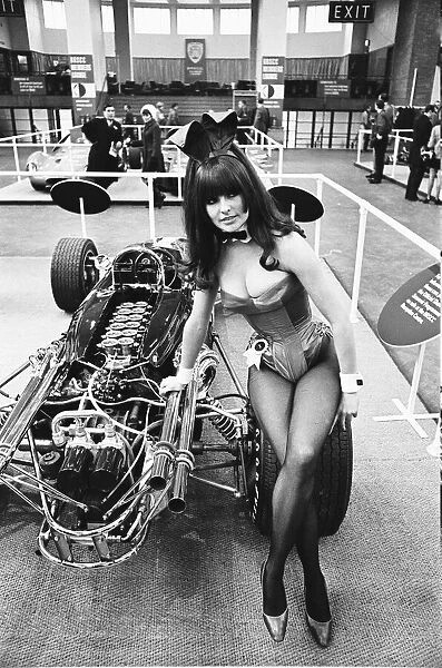 Model drapped over a hot rod dragster car at Motor Show at Horticultural Hall 2nd January