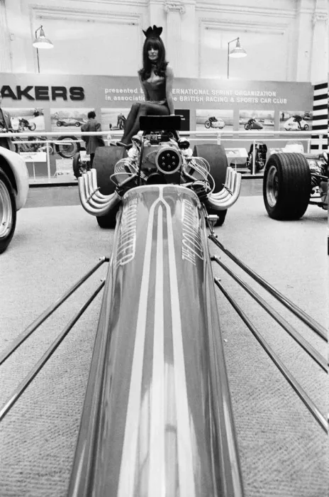 Framed Print : Model drapped over a hot rod dragster car at Motor Show at Horticultural Hall 2nd January