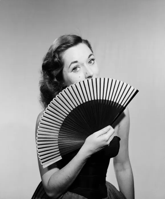 Framed Print : Model with fan in strapless dress. Model with fan in strapless dress. Circa 1964