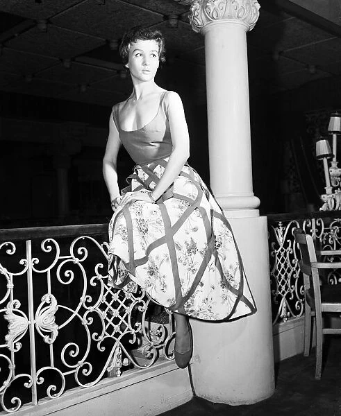Model, Guislaine, pictured wearing a bold swoop neckline dress designed by Italian