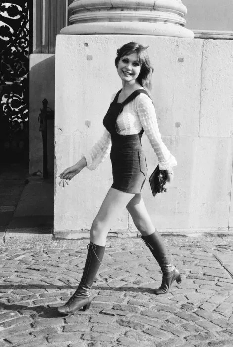 Framed Print : Model and horror film actress Madeline Smith poses wearing hot pants suit with knee high