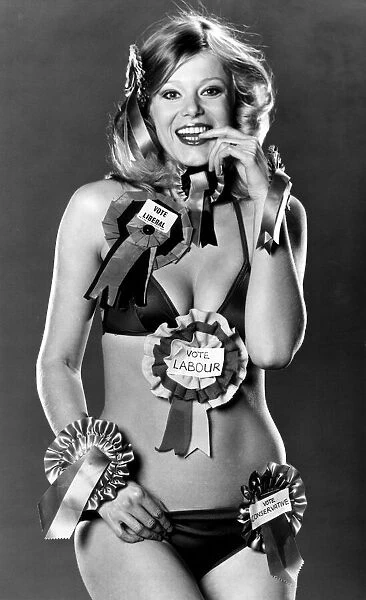 Model Jan Burdette wearing a collection of rosettes on the day of the General Election