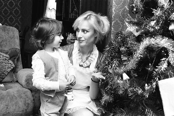 Model Janet Slaven seen here helping to dress a Christmas tree December 1982