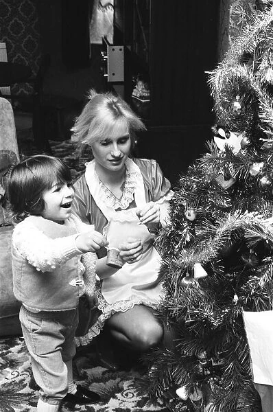Model Janet Slaven seen here helping to dress a Christmas tree December 1982