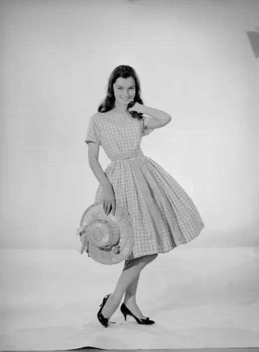 Framed Print : Model Jennifer Goddard. Brown-haired girl in checkered dress with hat
