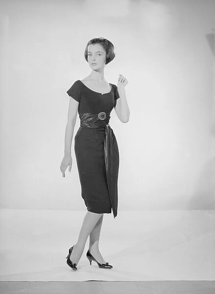 Model Jennifer Goddard. Young woman in short dressy black dress