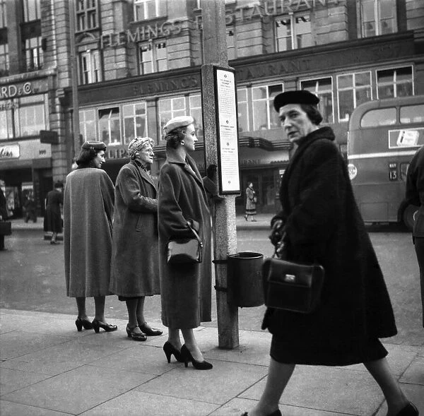 Model: Jennifer Randolph seen here queuing at the bus stop. November 1953 D6706