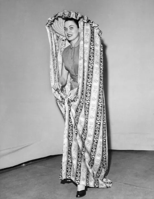 Framed Print : Model Julie Wilson wearing a printed mobile changing curtain June 1951 Framed Print : Model Julie Wilson wearing a printed mobile changing curtain June 1951