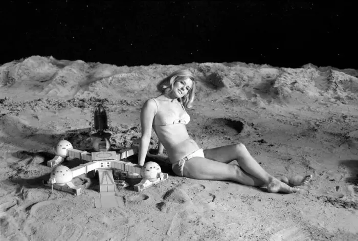 Framed Print : Model June Cooper poses for pictures with a backdrop designed as the surface of the moon Framed Print : Model June Cooper poses for pictures with a backdrop designed as the surface of the moon