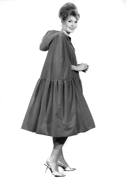 Model Liz Duke wearing a coat with hood. December 1962 P008880