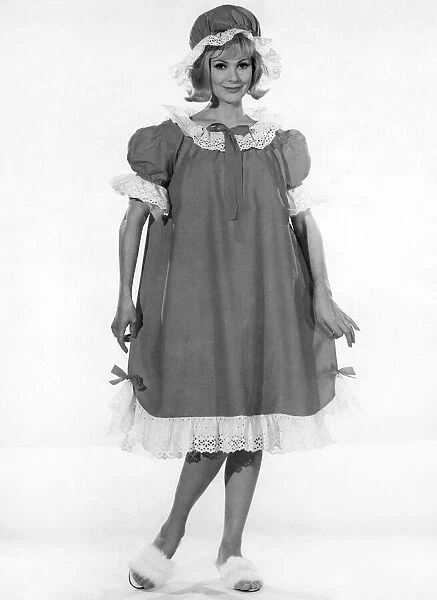 Model Margaret London wearing a long baggy style night dress with frilly trims