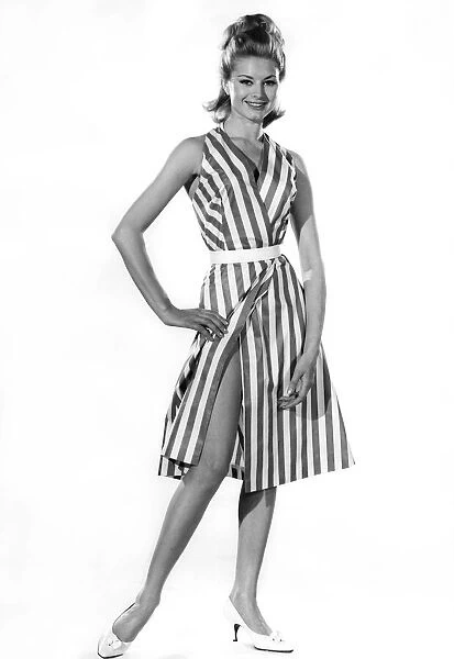 Model Margaret Lorraine wearing striped sleeveless dress with bellt